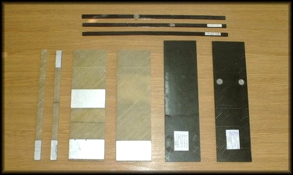 Glass/epoxy and graphite/epoxy composite beams and plates with cracks or delaminations for vibration tests