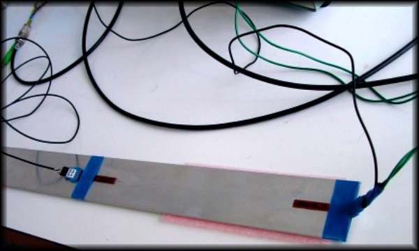 Damaged glass/epoxy composite beam with piezo transducers